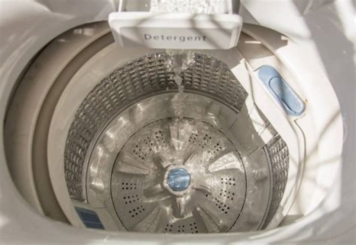 How do you level a top loading washing machine?